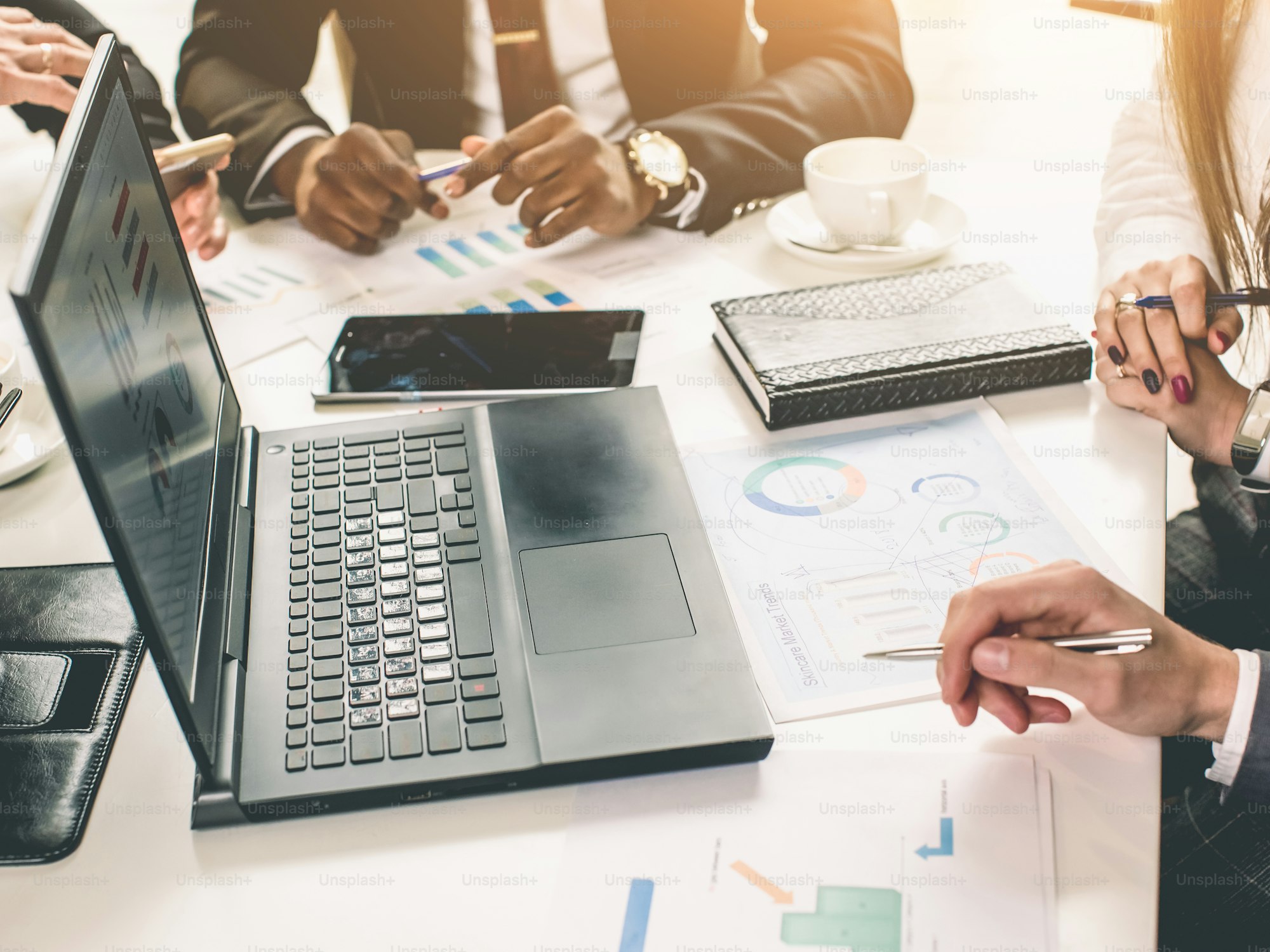 A team of professionals reviewing data and dashboards together in a modern office